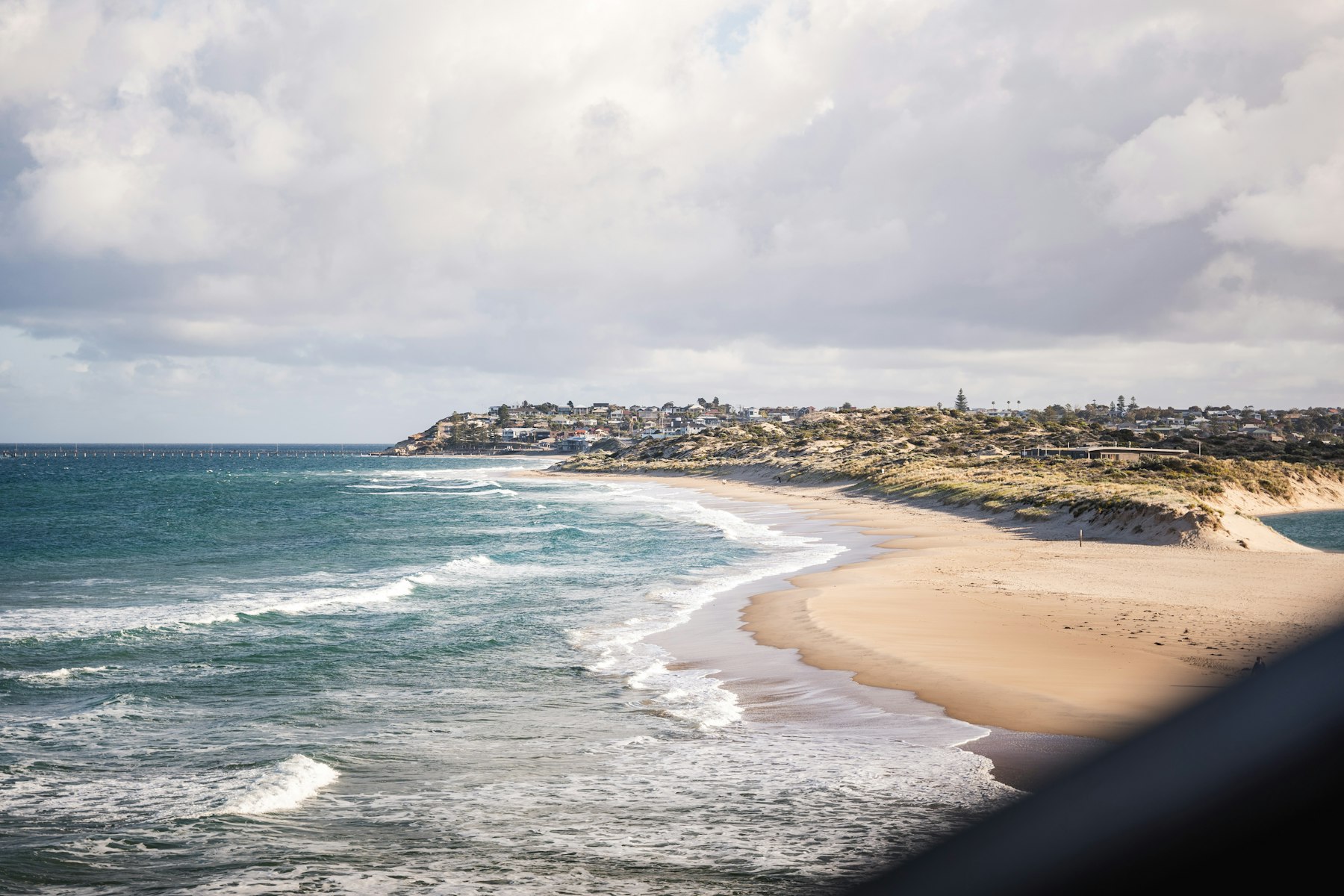 Southern Adelaide coastline with surf breaking along the beach