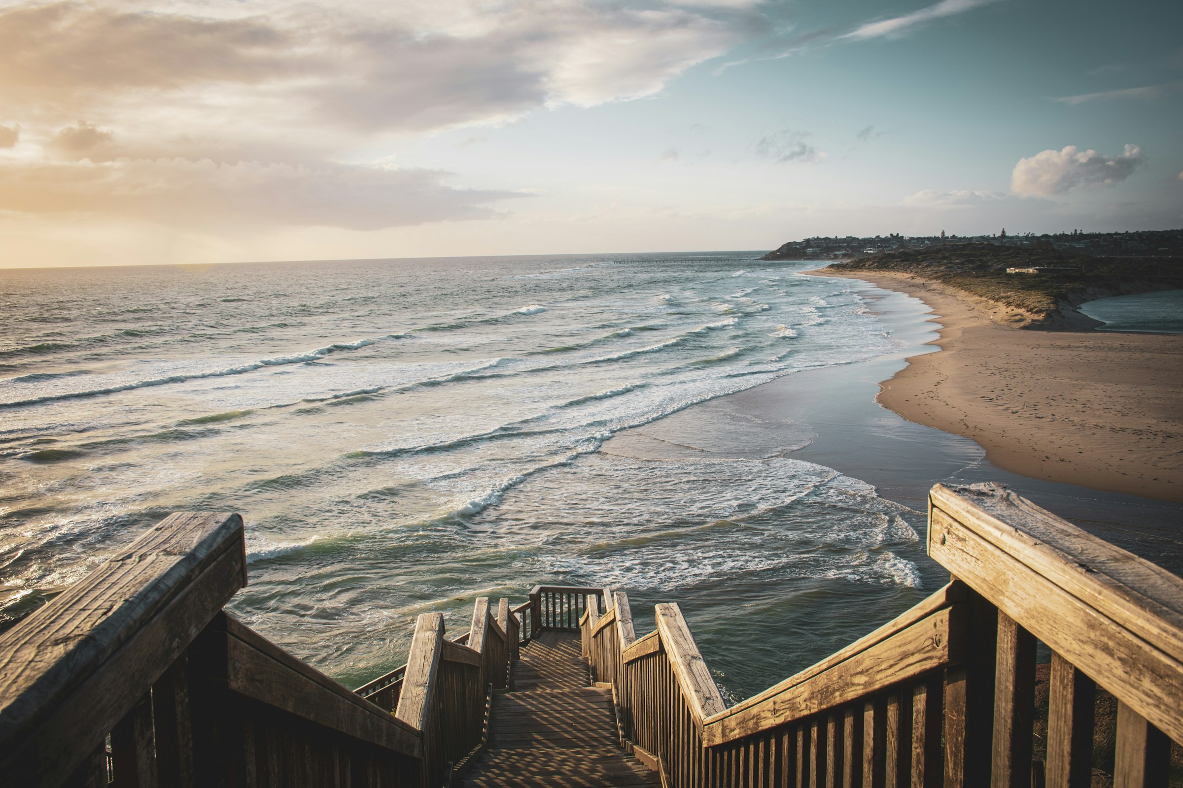 Timber beach stairs above the surf on Adelaide's southern coast at dusk