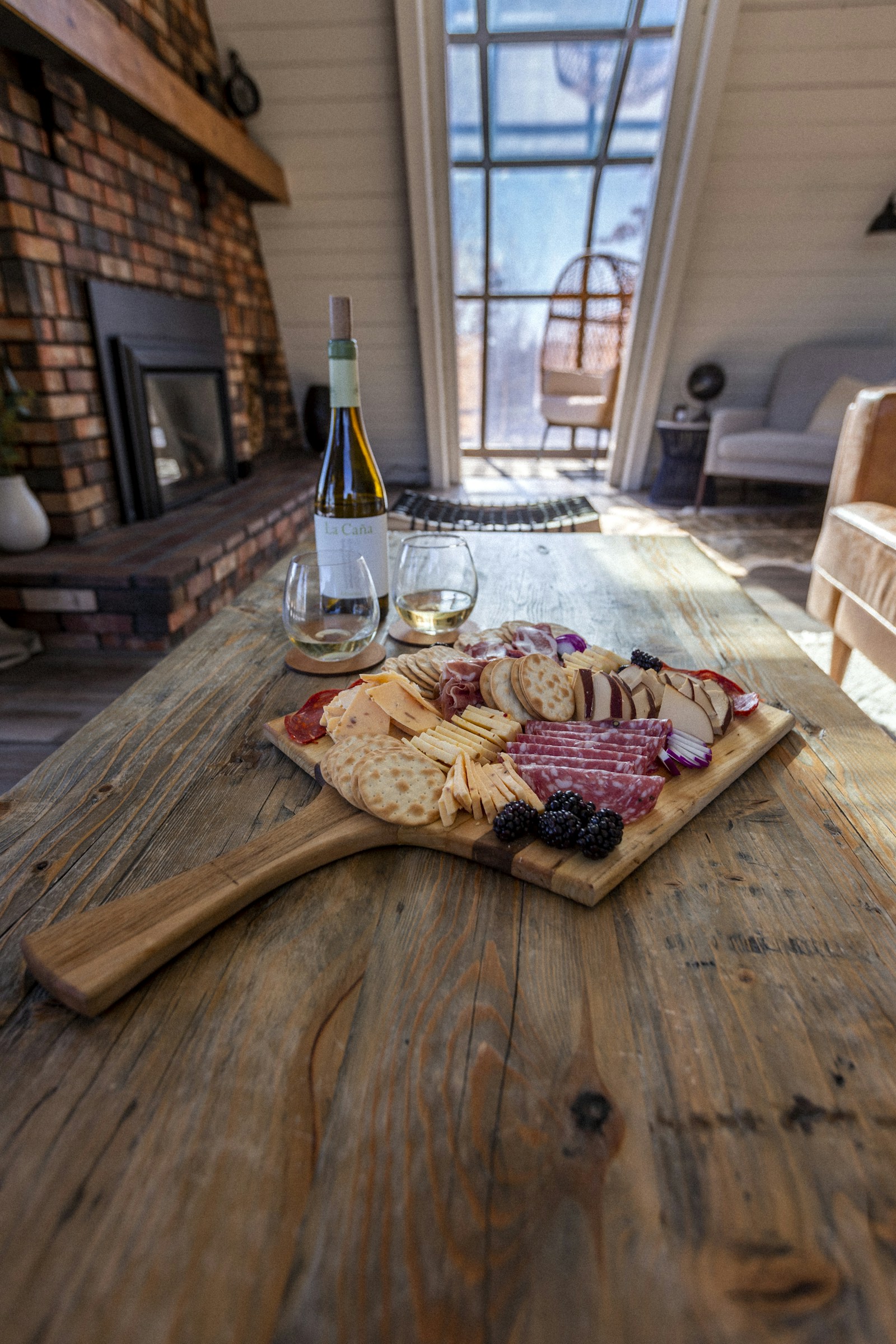 A curated arrival platter of cheese, crackers, grapes and nuts prepared for Aurea guests